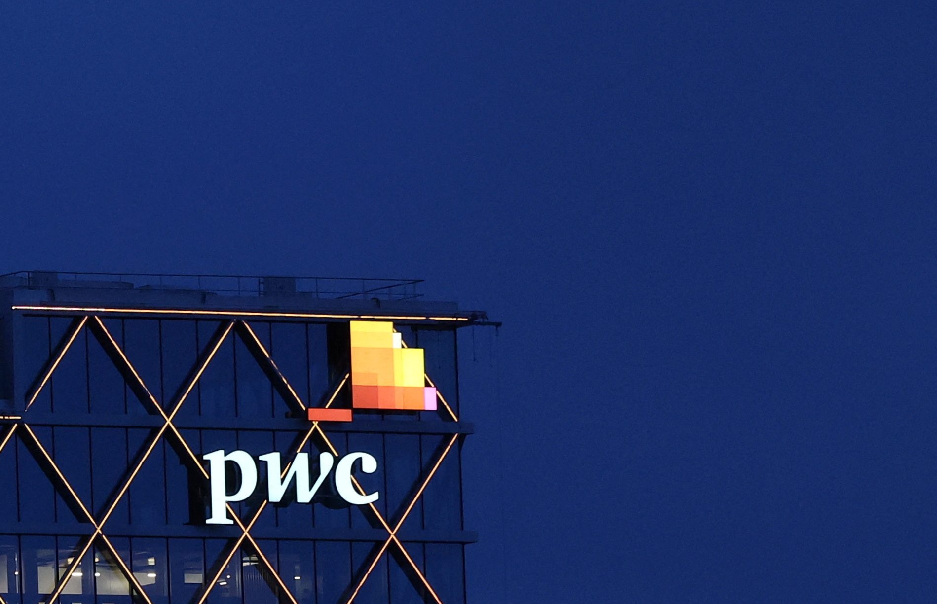 Hit by client exits, PwC to slash China partners' pay by up to 50%